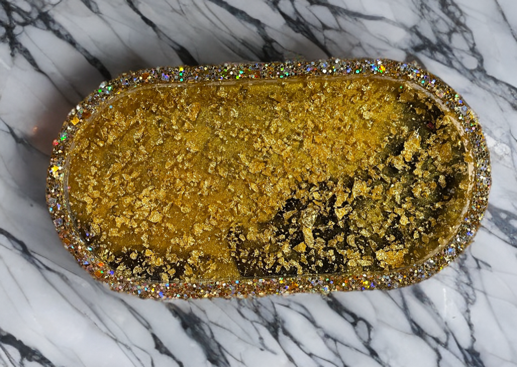 Gold glittery clutch on a marble surface